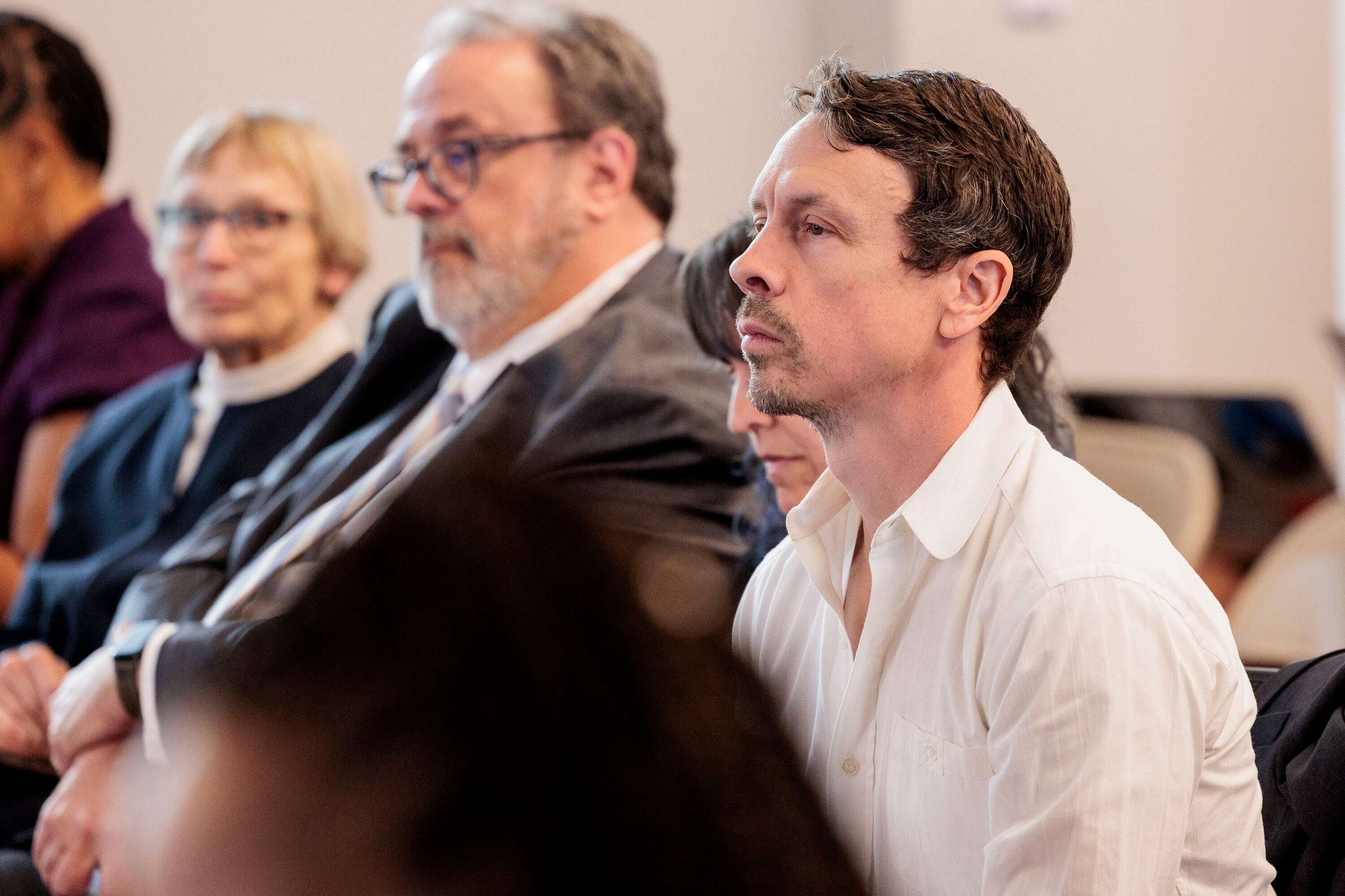 John Benson, Ann Arbor school board candidate, listens to comments at a meeting on Wednesday, June 3, 2026.