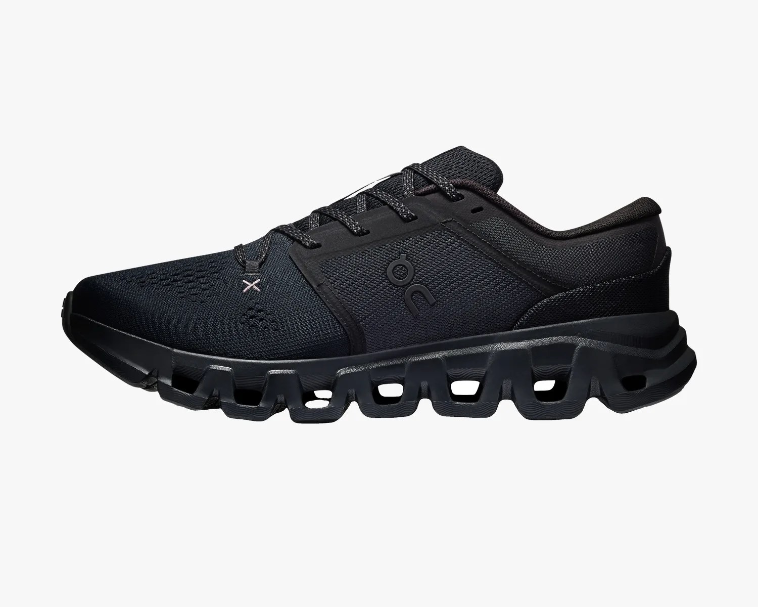 Black athletic shoe with mesh upper and unique segmented sole design, featuring "on" logo on the side.