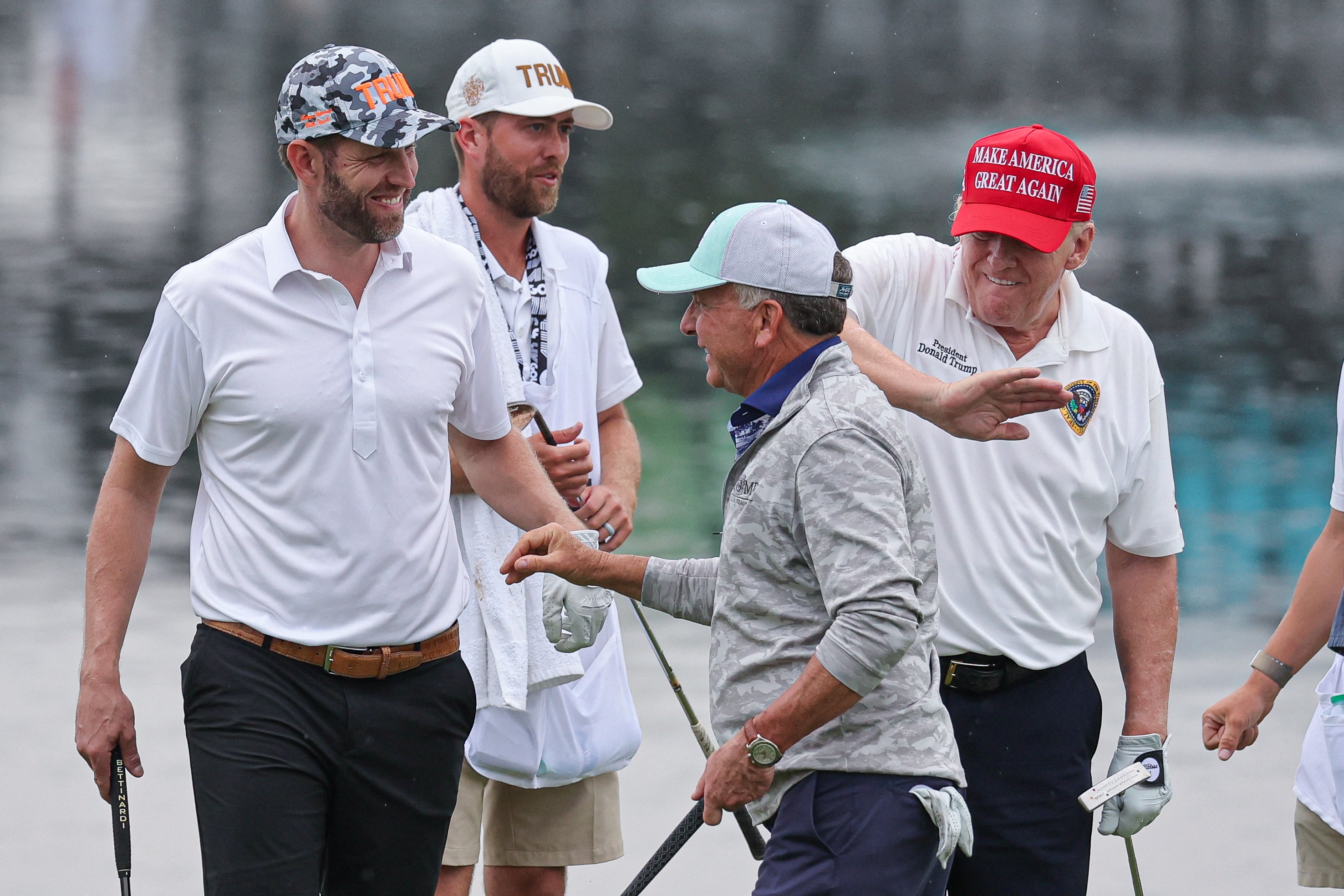 Trump pats Witkoff on the back on the golf course.
