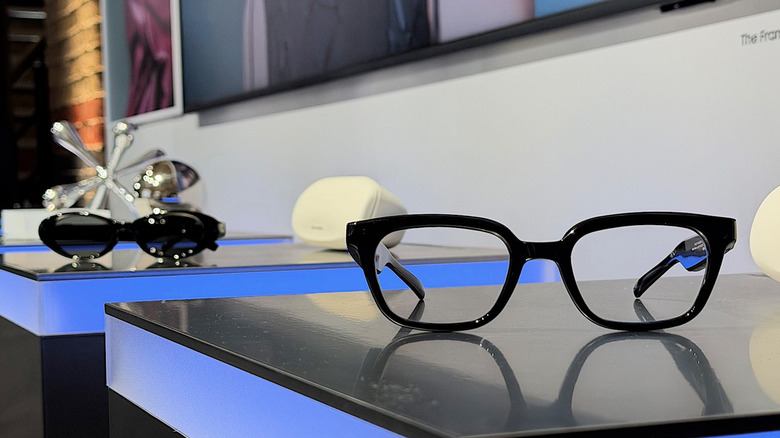 Two pairs of glasses on a table.