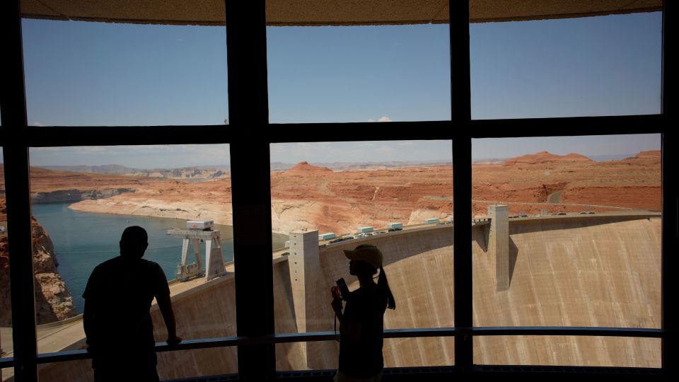 People look at the Glen Canyon Dam, Tuesday, July 14, 2026, near Page, Nevada. - John Locher/AP
