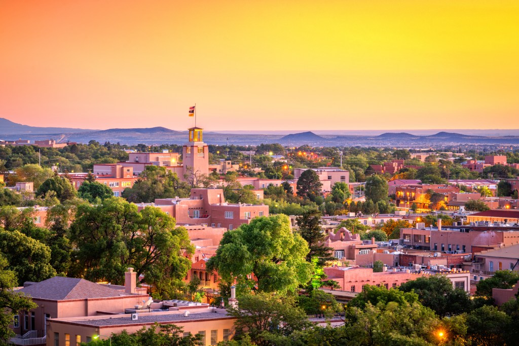 The downtown skyline of Santa Fe, New Mexico, at dusk.