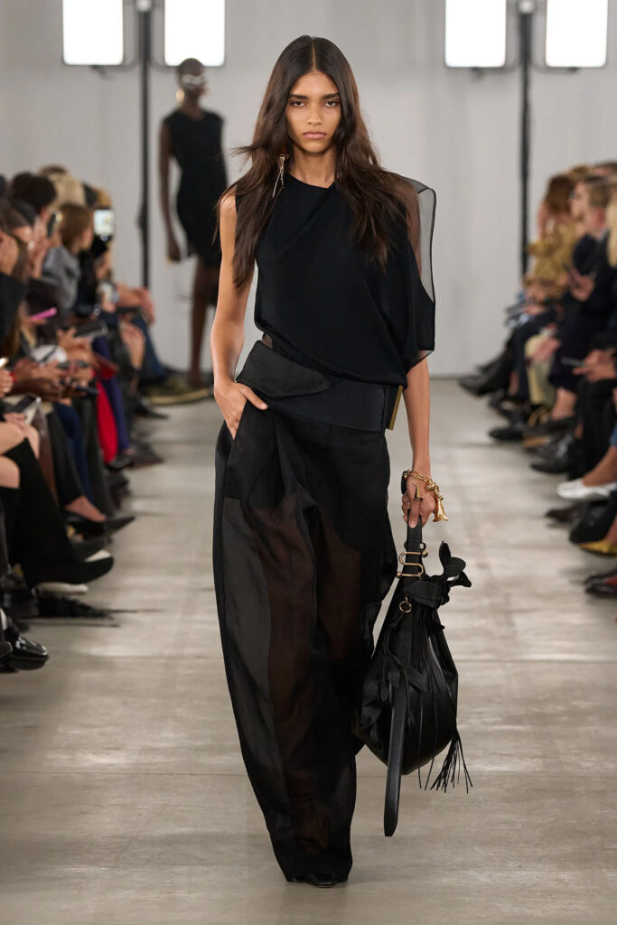 Sportmax Spring 2026 black asymmetric top and sheer organza trousers presented on the runway.