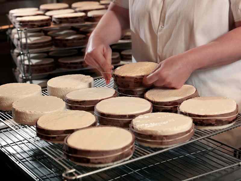 Winnimere cheese rounds being wrapped