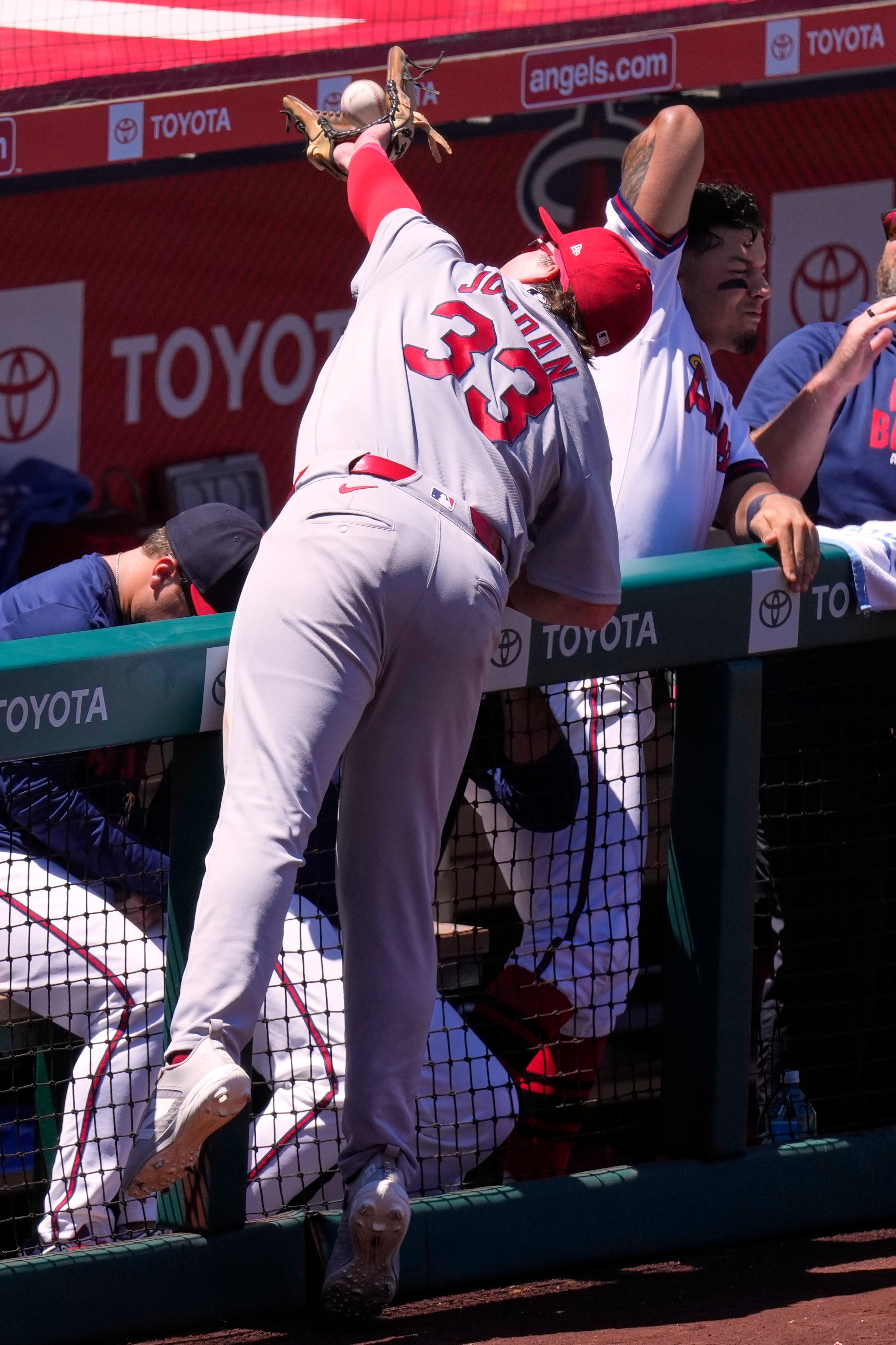St. Louis Cardinals third baseman Blaze Jordan, center, makes a catch on a foul ball hit by Los Angeles Angels' Tyler Heineman as Vaughn Grissom, right, gets out of the way during the fourth inning of a baseball game Wednesday, July 22, 2026, in Anaheim, Calif. (AP Photo/Mark J. Terrill)