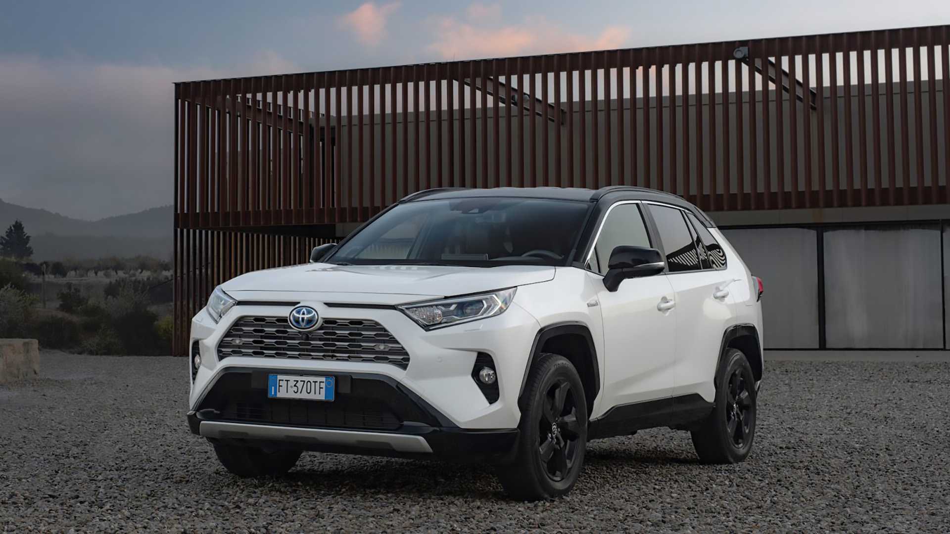 Front 3/4 shot of a White 2019 Toyota RAV4 Hybrid Parked