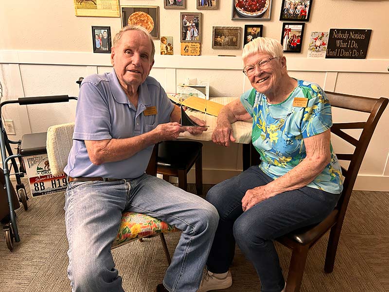 Jack Magnusson, left, and his wife, Lavine, pose for a photo inside their Lincoln Court apartment. | Rett Nelson, EastIdahoNews.com
