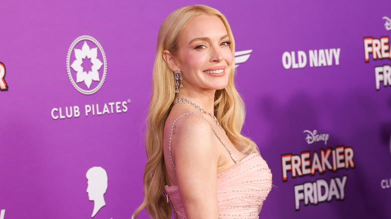 Lindsay Lohan smiles with her head turned to the side