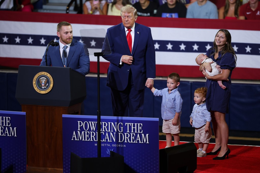 Trump holds hands with toddler and mocks ‘Pee-wee’ Jon Ossoff at Georgia Trump Accounts rally