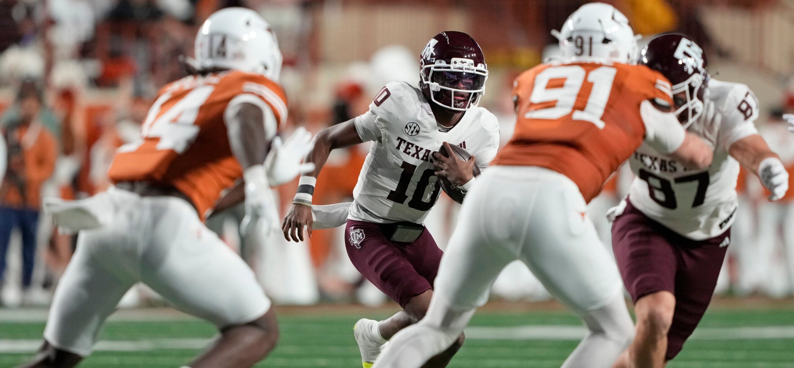Nov 28, 2025; Austin, Texas, USA; Texas A&M Aggies quarterback Marcel Reed (10) keeps the ball for yardage during the first half against the Texas Longhorns at Darrell K Royal-Texas Memorial Stadium. Mandatory Credit: Scott Wachter-Imagn Images
