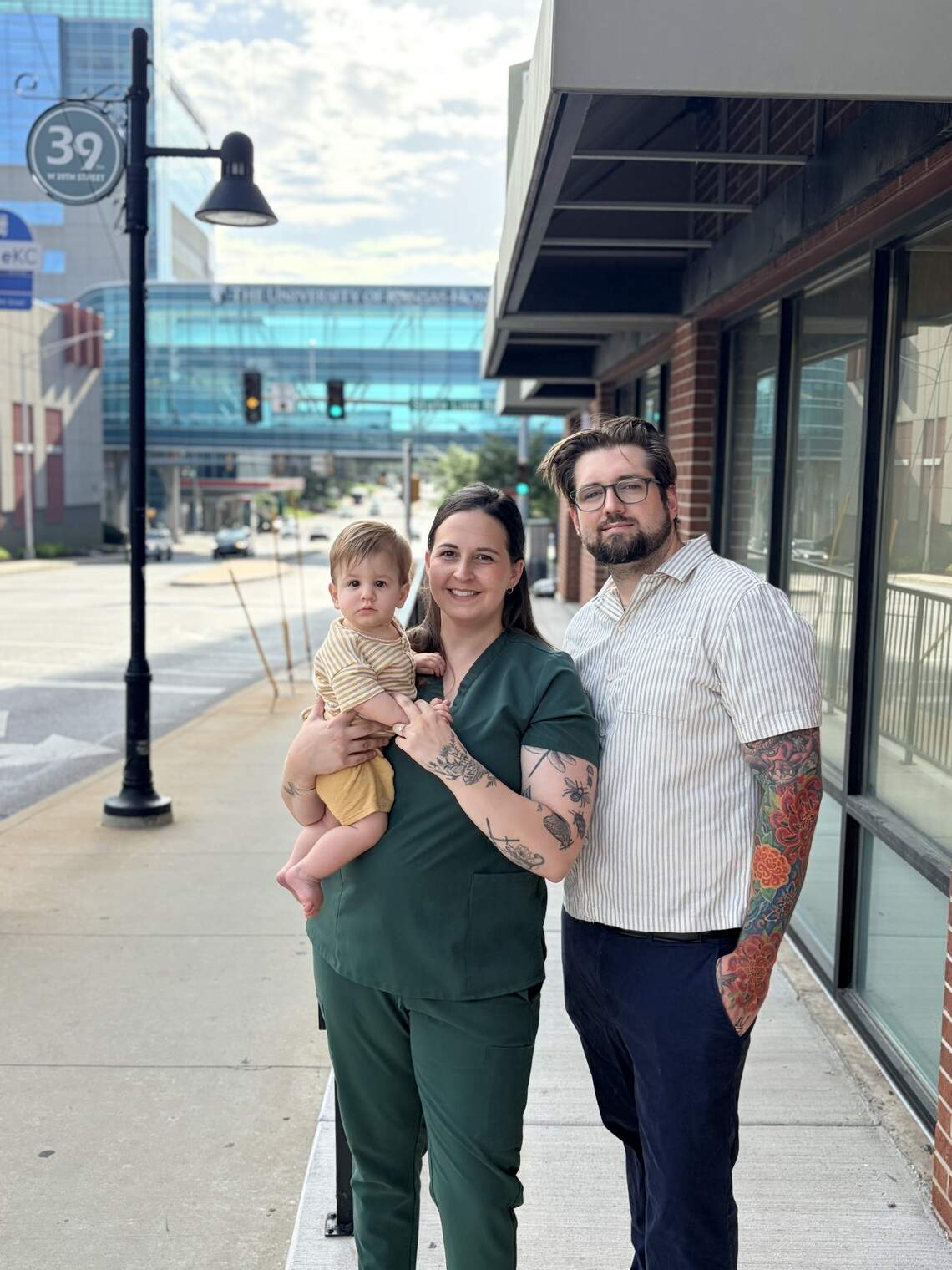 Kory Roth with his wife Emily Roth and their baby in front of his soon-to-open Marigolds.