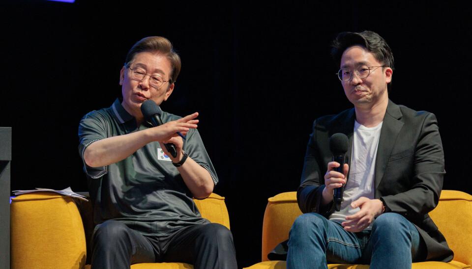 Tekken pro-gamer Bae Jae-min, right, sits with then-presidential candidate Lee Jae Myung during a town hall meeting about esports held in Gwangju in 2025.