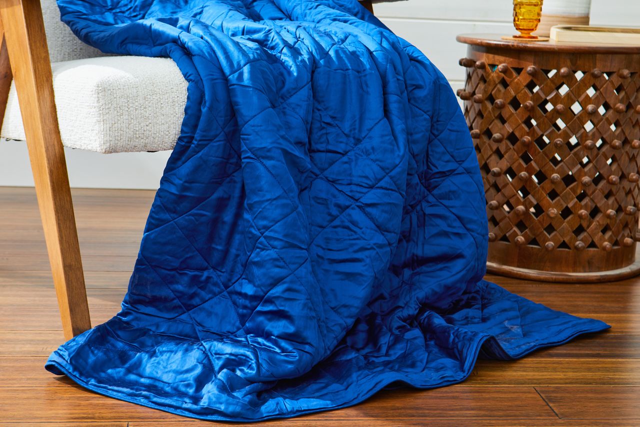 The Luxome Lightweight Blanket draped over a chair