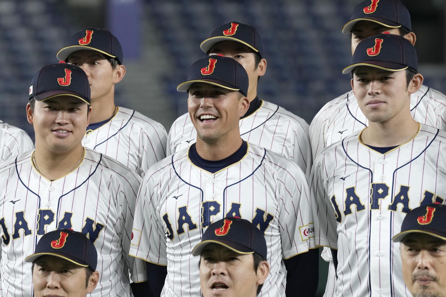 Japan's Lars Nootbaar, center, smiles as he attends a group photo session prior to a World Baseball Classic practice in Tokyo