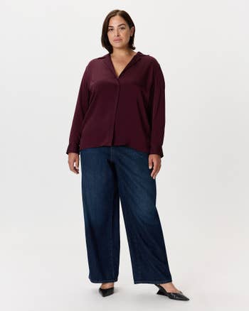 Person wearing a casual, flowy blouse and wide-leg jeans, suitable for a relaxed outing or everyday wear