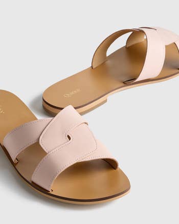 Two stylish flat sandals with wide, cross-strap design, suitable for casual or semi-formal outfits