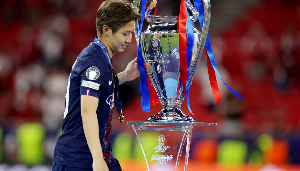 Paris Saint-Germain's Lee Kang-in celebrates with the trophy after winning the UEFA Champions League on May 31.