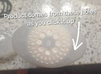 Close-up of a dispenser lid with text: