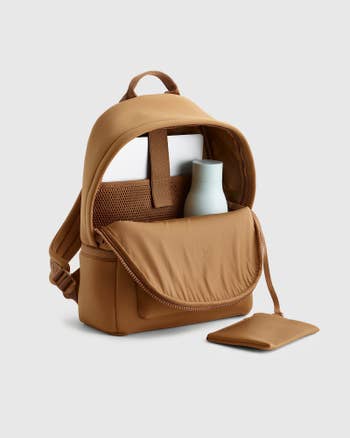 Open backpack with tablet sleeve and water bottle inside, suitable for work or travel