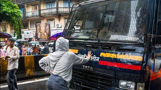 Mumbai, India. July 22, 2026 - A protester blocked a police vehicle near Shiv Sena Bhavan in Dadar as police detained students during the Mumbai protest. Several student organisations and Cockroach Janta Party supporters gathered there to show solidarity with the CJP's protest in Delhi. Mumbai, India.