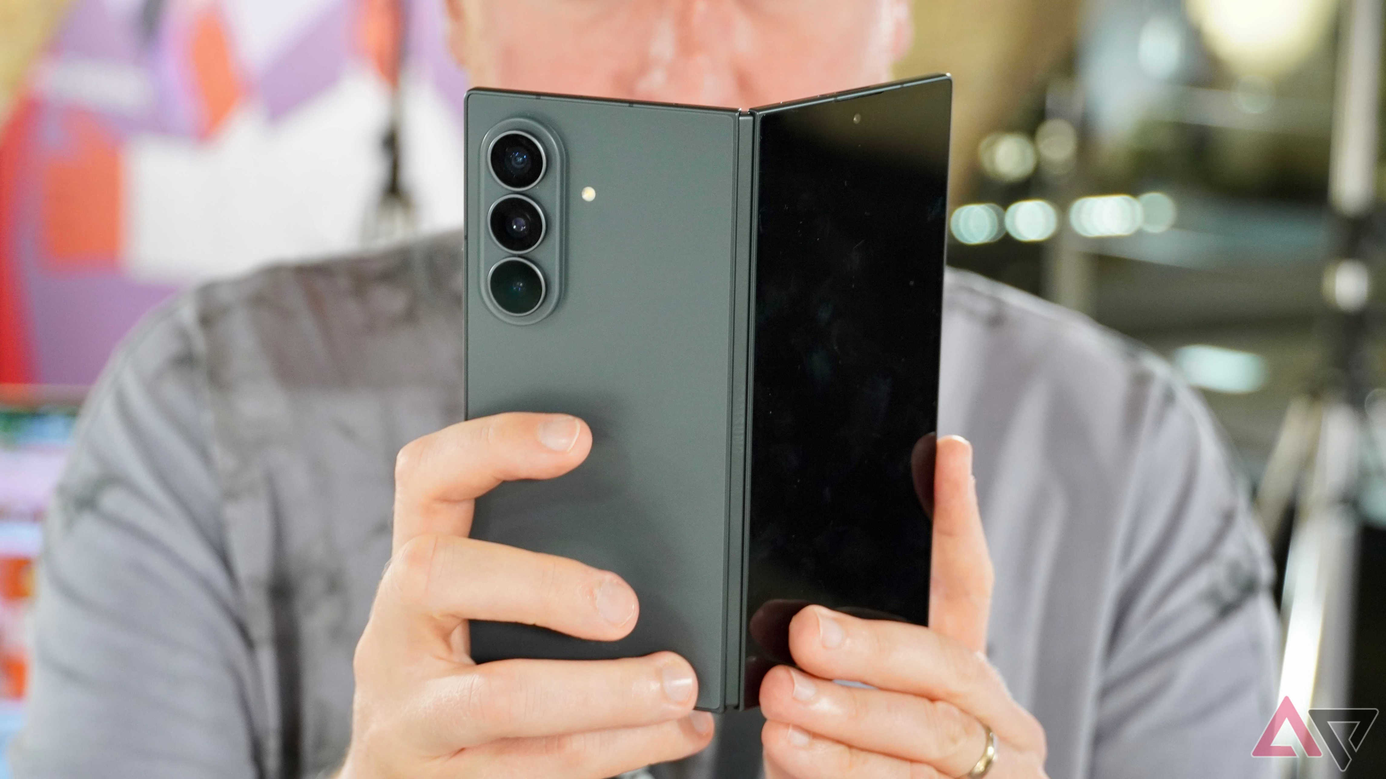 A person closing the Samsung Galaxy Z Fold 8 Ultra
