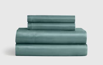 Folded set of neatly stacked bed sheets on a plain background, featured in a shopping article