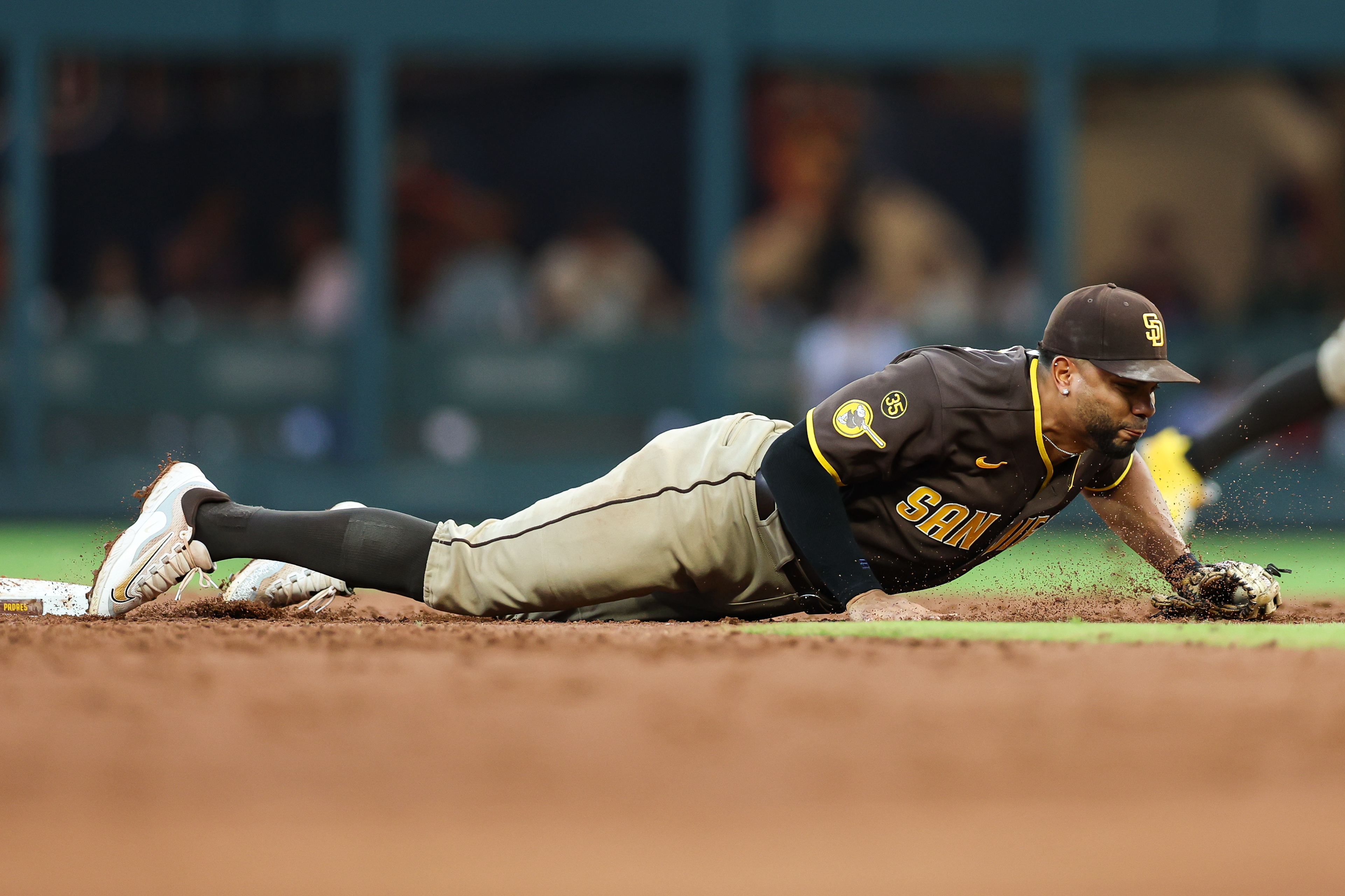 San Diego Padres shortstop Xander Bogaerts tags second base in the third inning of a baseball game against the Atlanta Braves, Wednesday, July 22, 2026, in Atlanta. (AP Photo/Colin Hubbard)