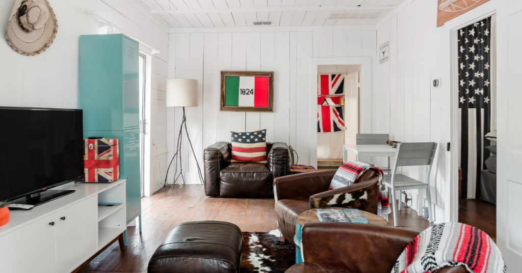 A vintage inspired living room with white paneled walls and colorful touches in an Austin Texas Airbnb.