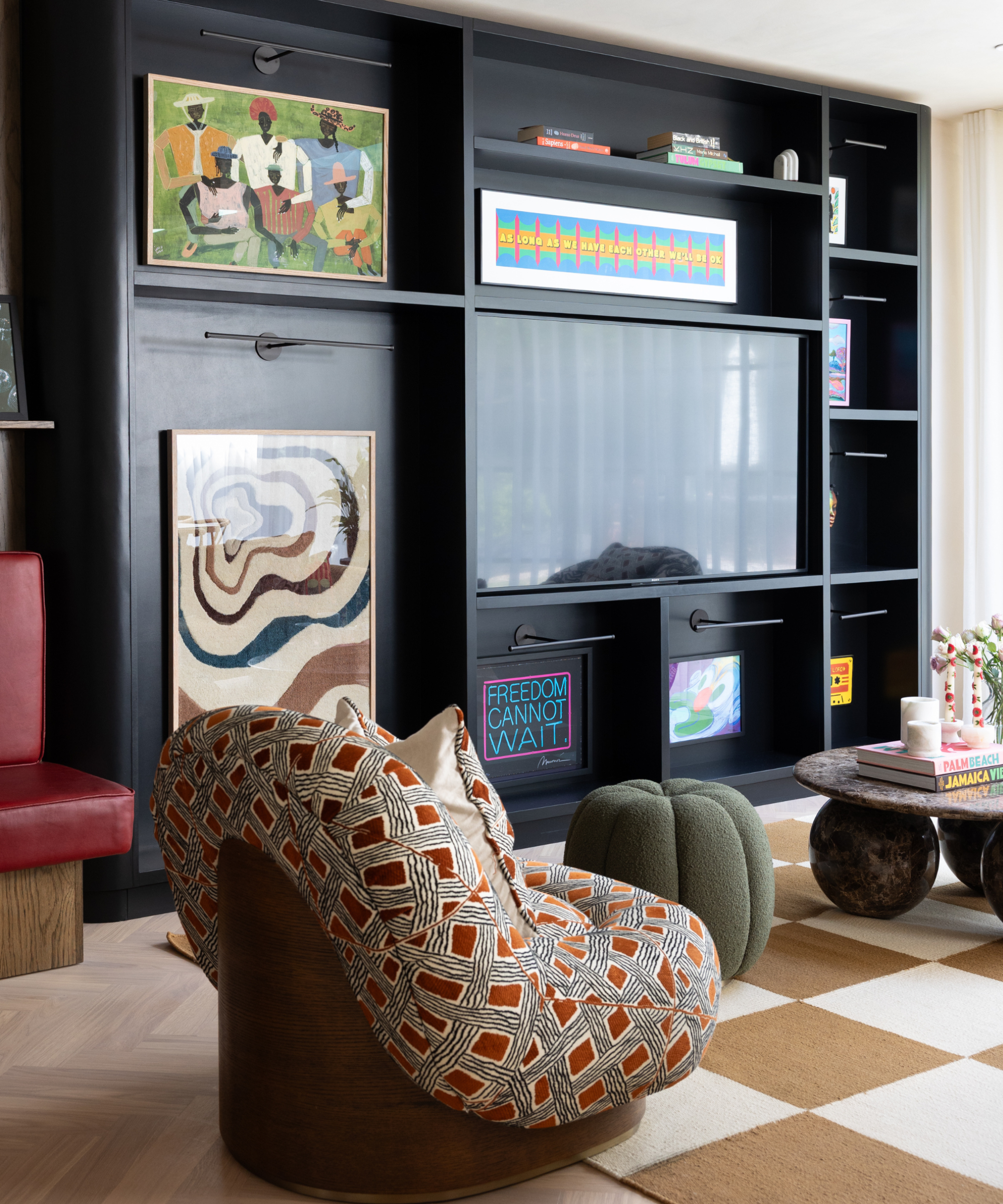 sitting room with checkerboard rug and artwork and patterned chair