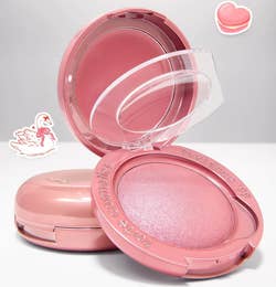 Open macaron-shaped Tarte blush compact showcasing cream and powder blushes