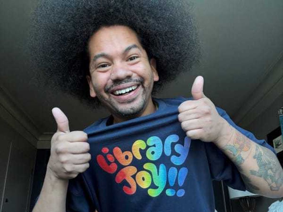 Mychal Threets wearing Library Joy shirt | Photo courtesy of Mychal Threets