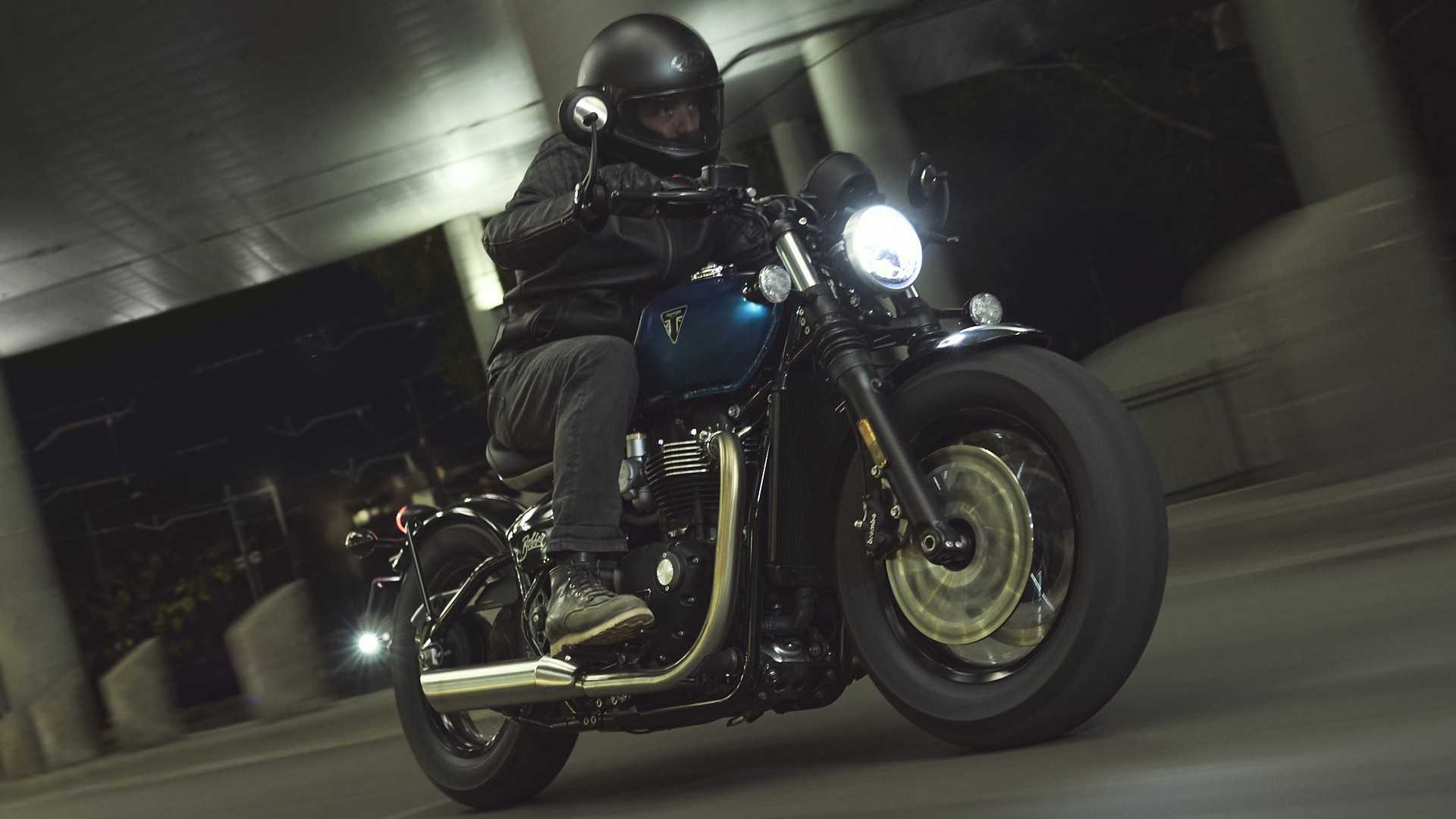 2026 Triumph Bonneville Bobber being ridden through a tunnel front third quarter rolling shot