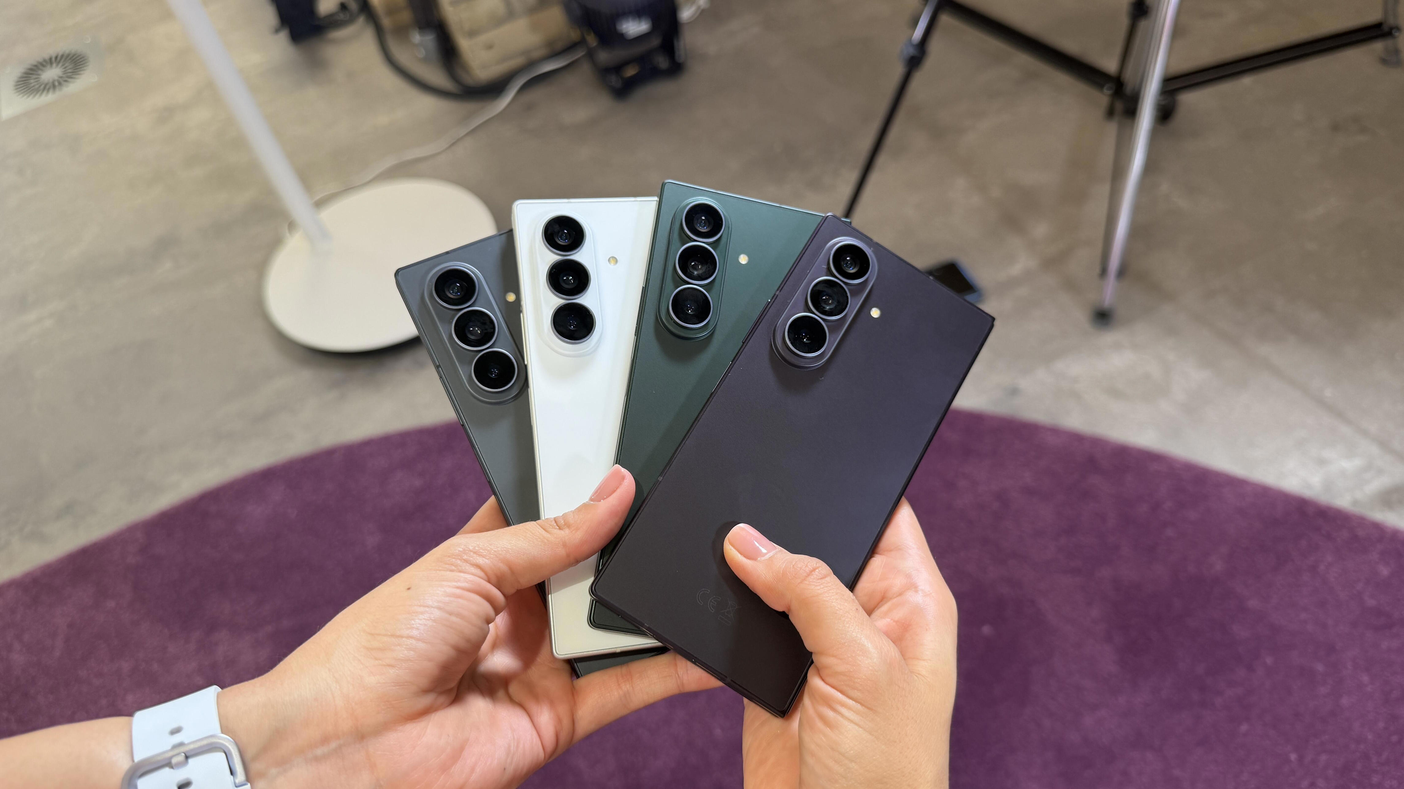 Woman holding all four colorways of the Samsung Galaxy Z Fold 8 Ultra