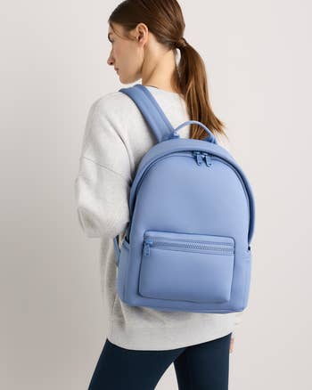 Person wearing a casual outfit with a minimalist backpack, suitable for everyday use