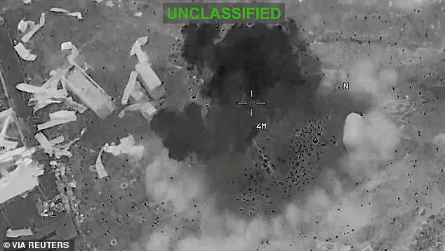 Scattered debris and smoke, at an unknown location, during what CENTCOM says are strikes on Iran