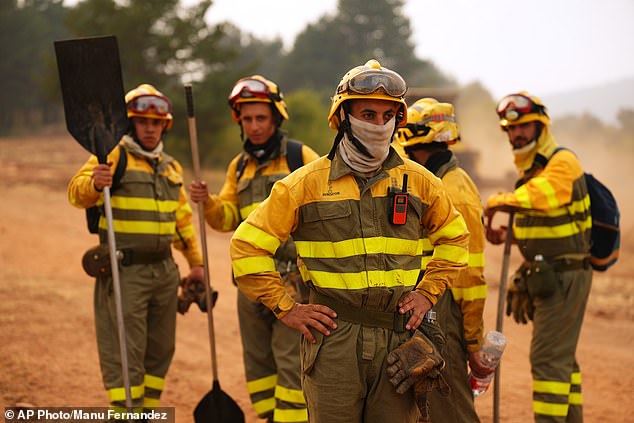 Forest rangers take a break before returning to work on the fire near Condemios de Arriba, Guadalajara province, Spain, Wednesday, July 22
