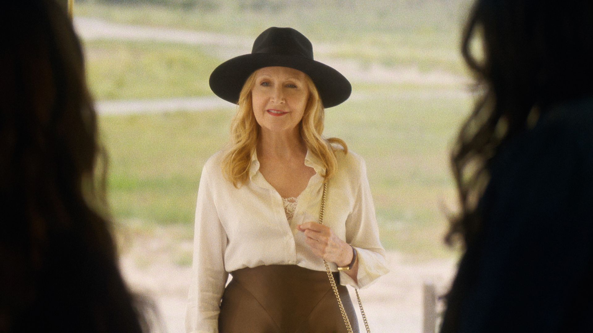 Claire stands at the door facing her two daughters