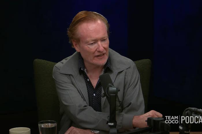 A person speaking into a microphone during a podcast recording