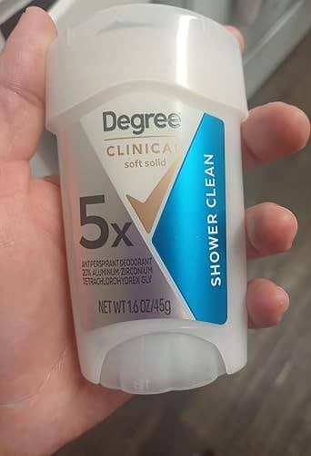 Hand holding Degree Clinical Strength antiperspirant deodorant,