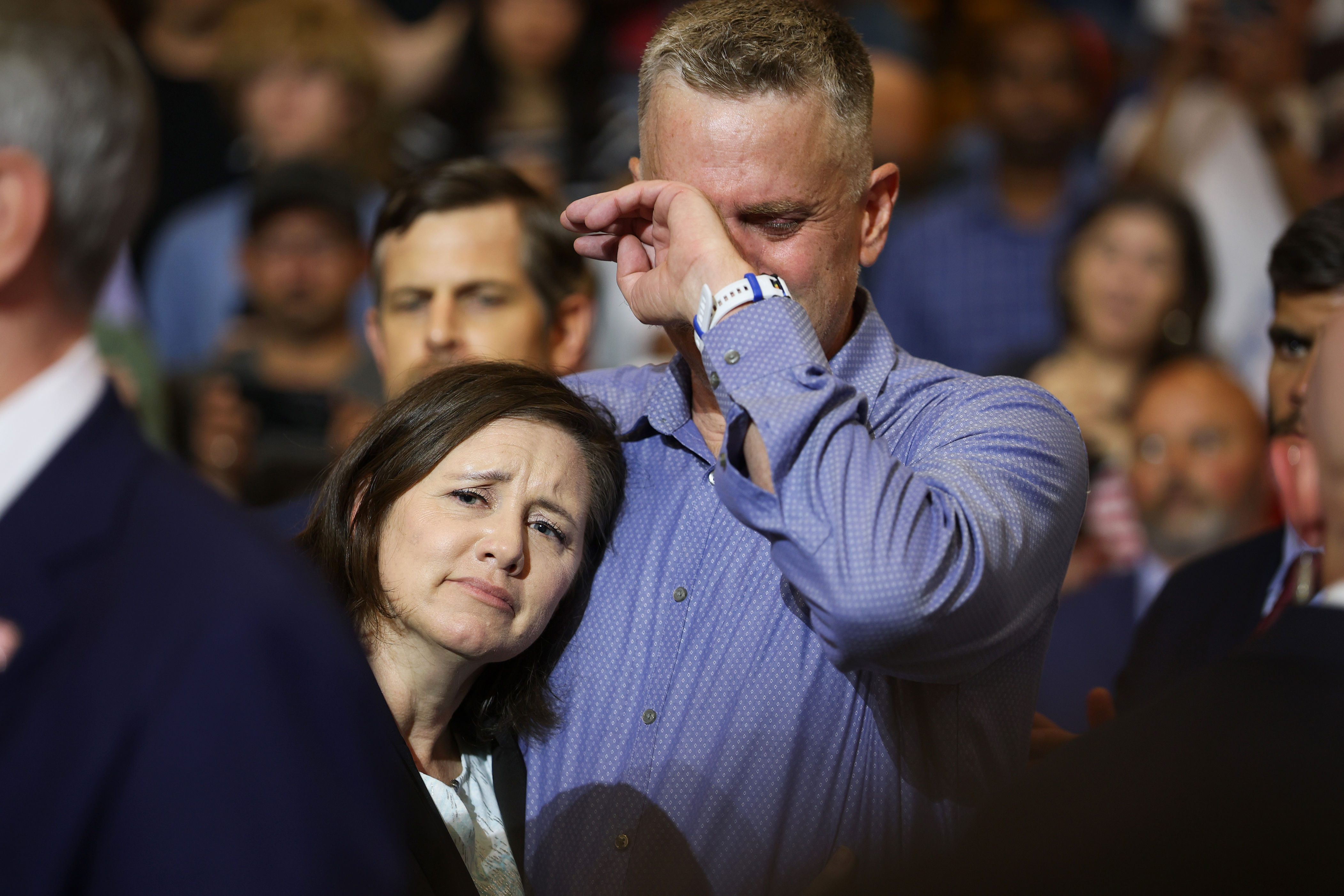 Stephen and Shari Feehan, the parents of U.S. Army 1st Lt Tyler James Feehan, become emotional as they are recognized by U.S. President Donald Trump as he speaks at Wheeler High School on July 22,...