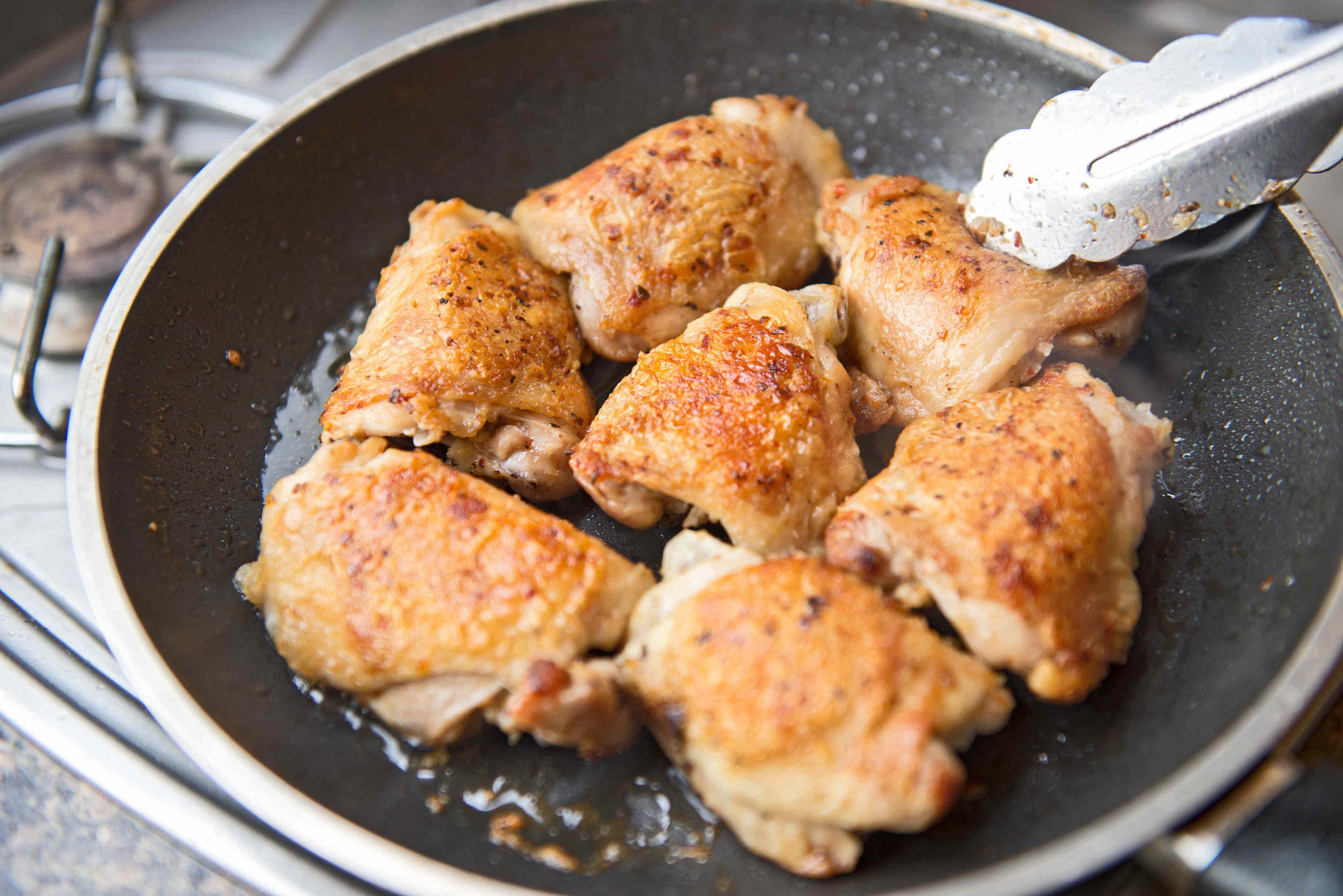 Chicken thighs in a frying pan