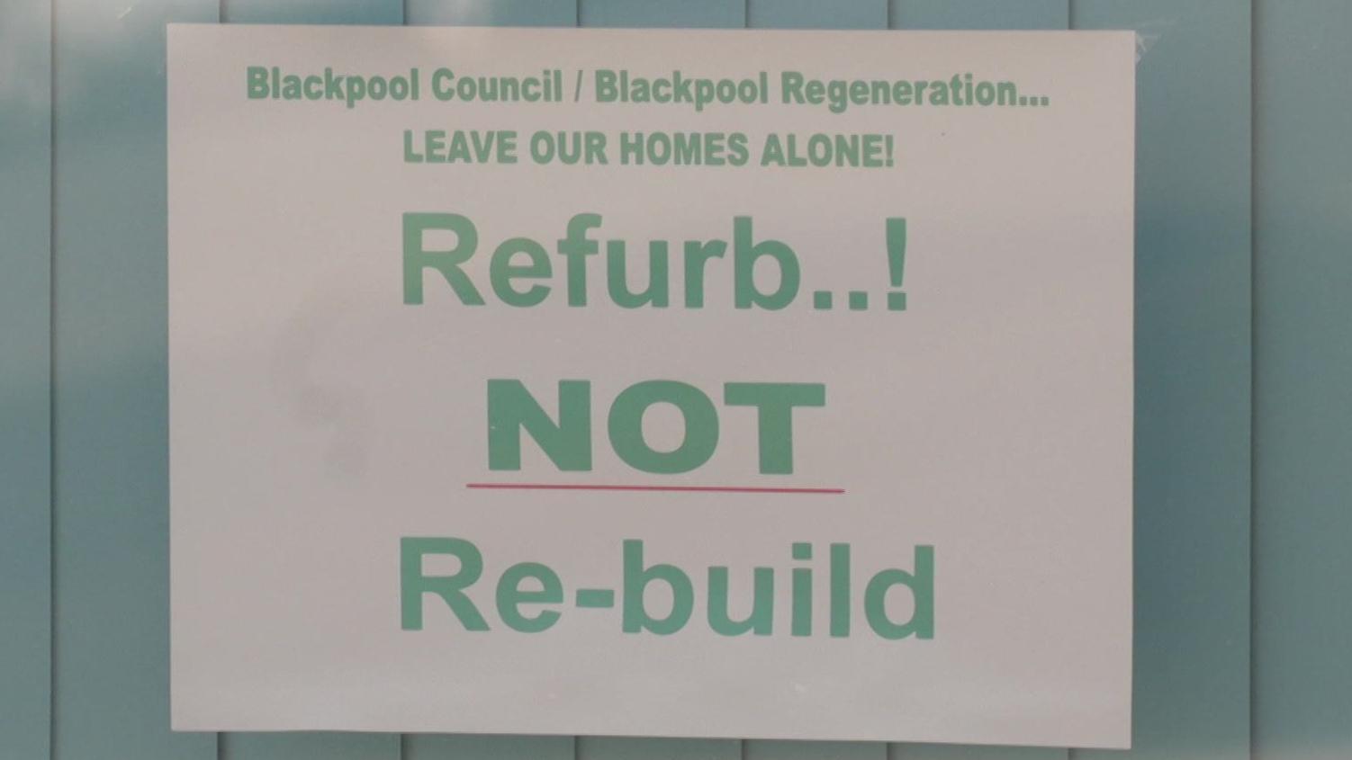 Signs have gone up in windows where residents remain urging refurbishment