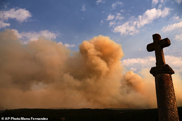 Smoke rises above the horizon as wildfire advances near Condemios de Arriba, Guadalajara province, Spain, Wednesday, July 22