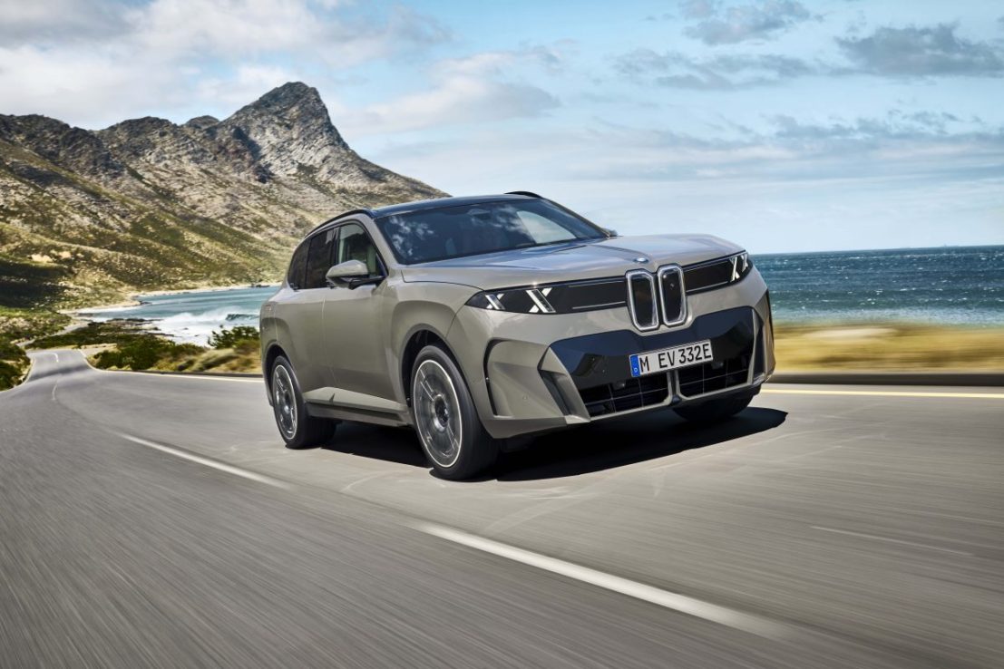 BMW electric SUV on a coastal road