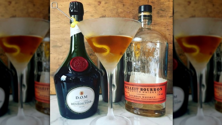 Kentucky Colonel in a cocktail glass with a bottle of bourbon and Bénédictine.