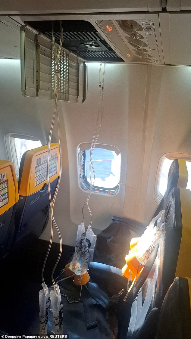 A broken window and the interior of the Ryanair aircraft, following a reported emergency landing