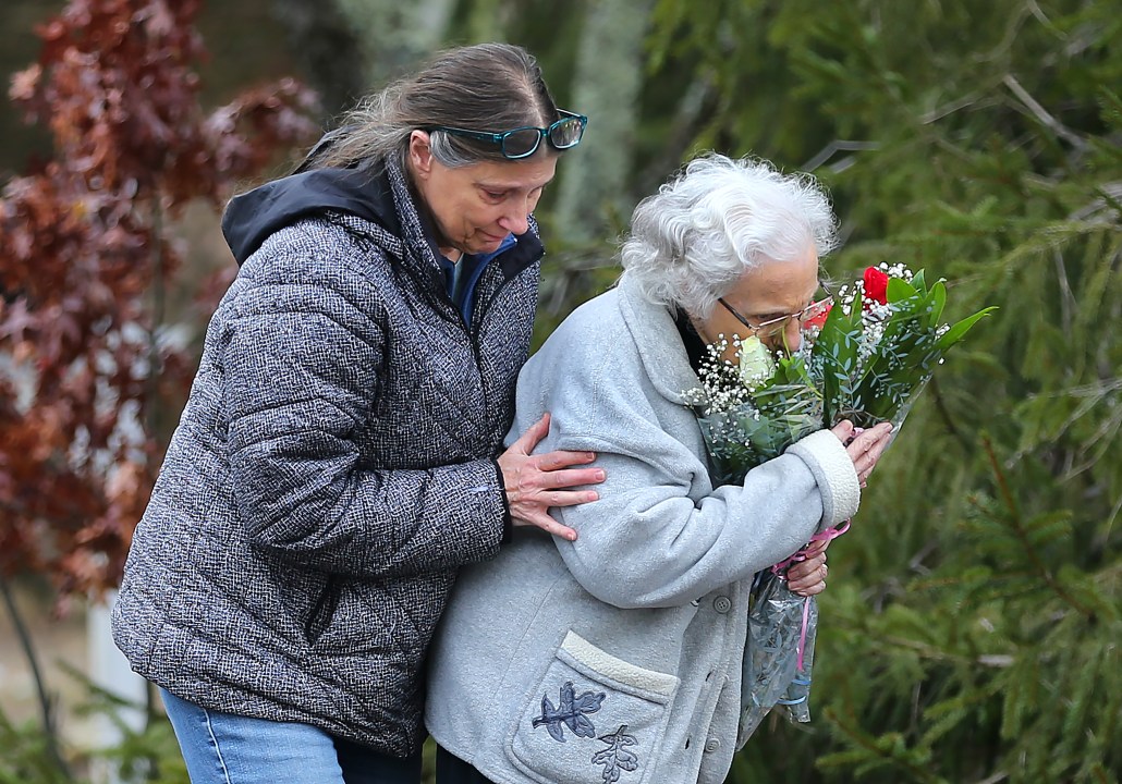 The aunt and great-grandmother of the victims stop by a make-shift memorial