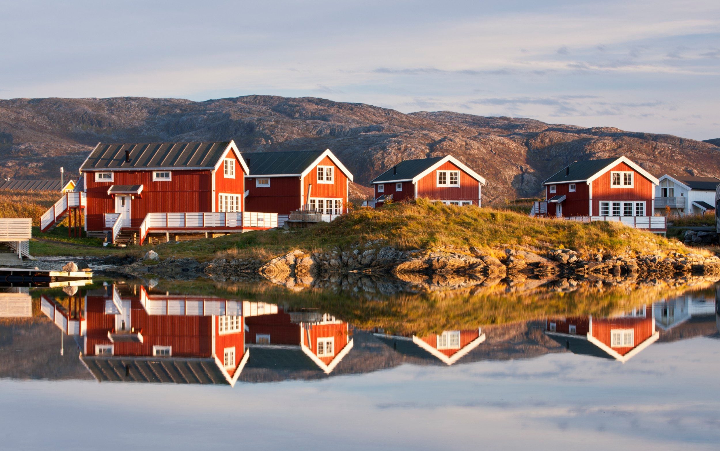 The sun shines on these houses for 68 days over the summer on the waters edge of Sommarøy