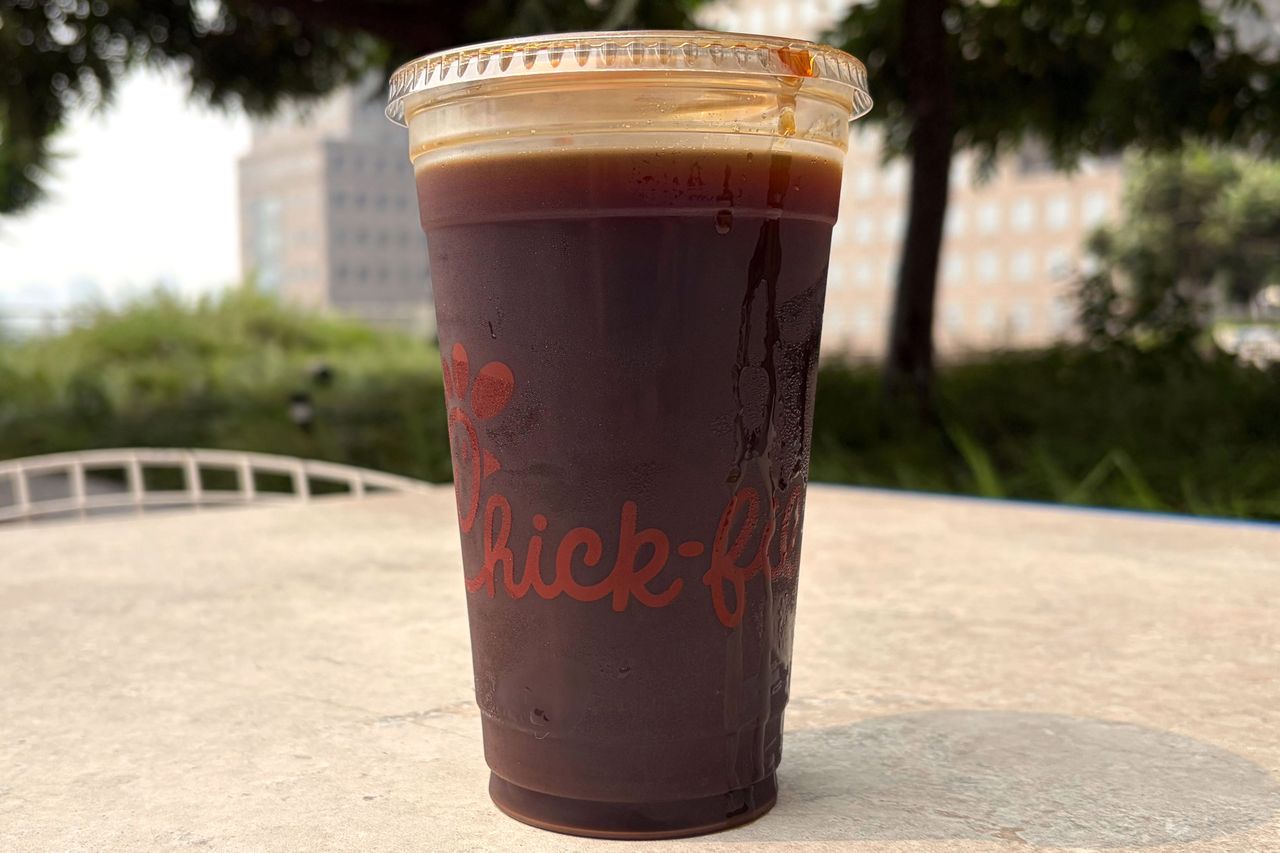 ChickfilA cold brew coffee in a clear cup on an outdoor table