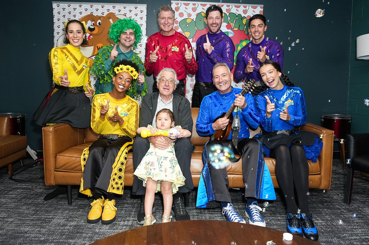 Robert De Niro and Gia Virginia Chen-De Niro meet (L-R) Evie Ferris, Tsehay Hawkins, Dominic Field, Simon Pryce, Lachlan Gillespie, John Pearce, Anthony Field and Lucia Field from The Wiggles during The Wiggles Bouncing Balls Tour at Kings Theatre on June 28, 2025 in New York City